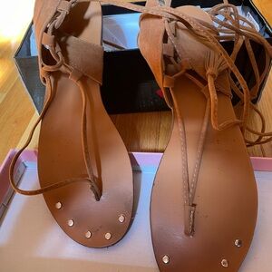 Tan suede lace up flat sandals. Worn once.. purchased in a local boutique